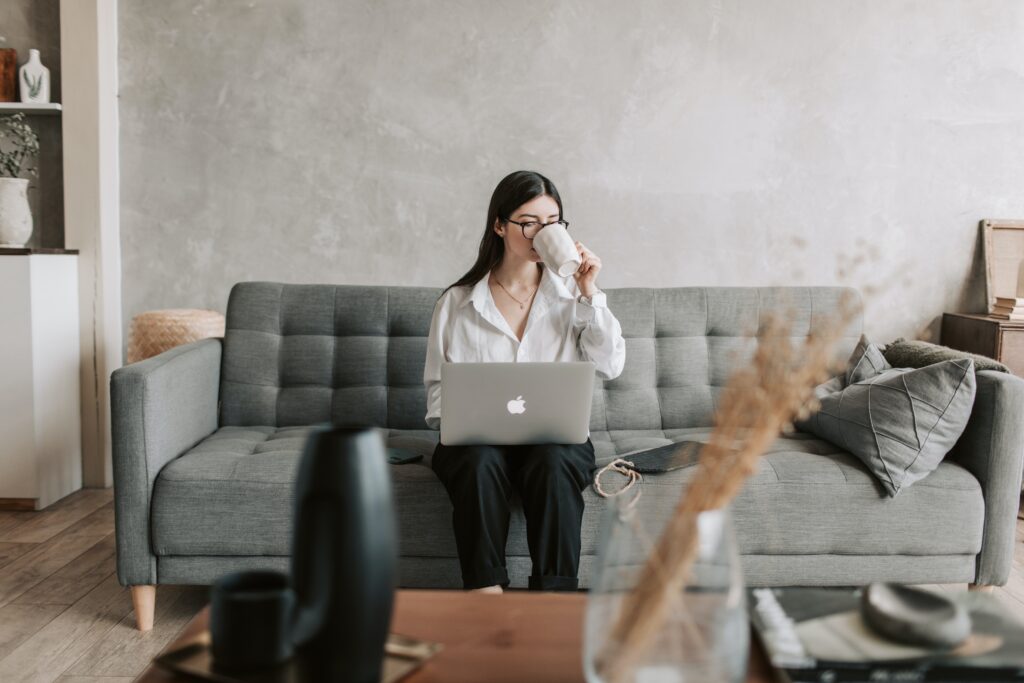 photo of a woman reading an email in the couch